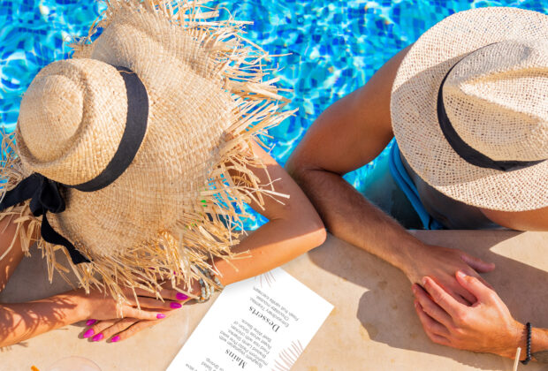 Couple enjoying drinks by the pool, overhead view